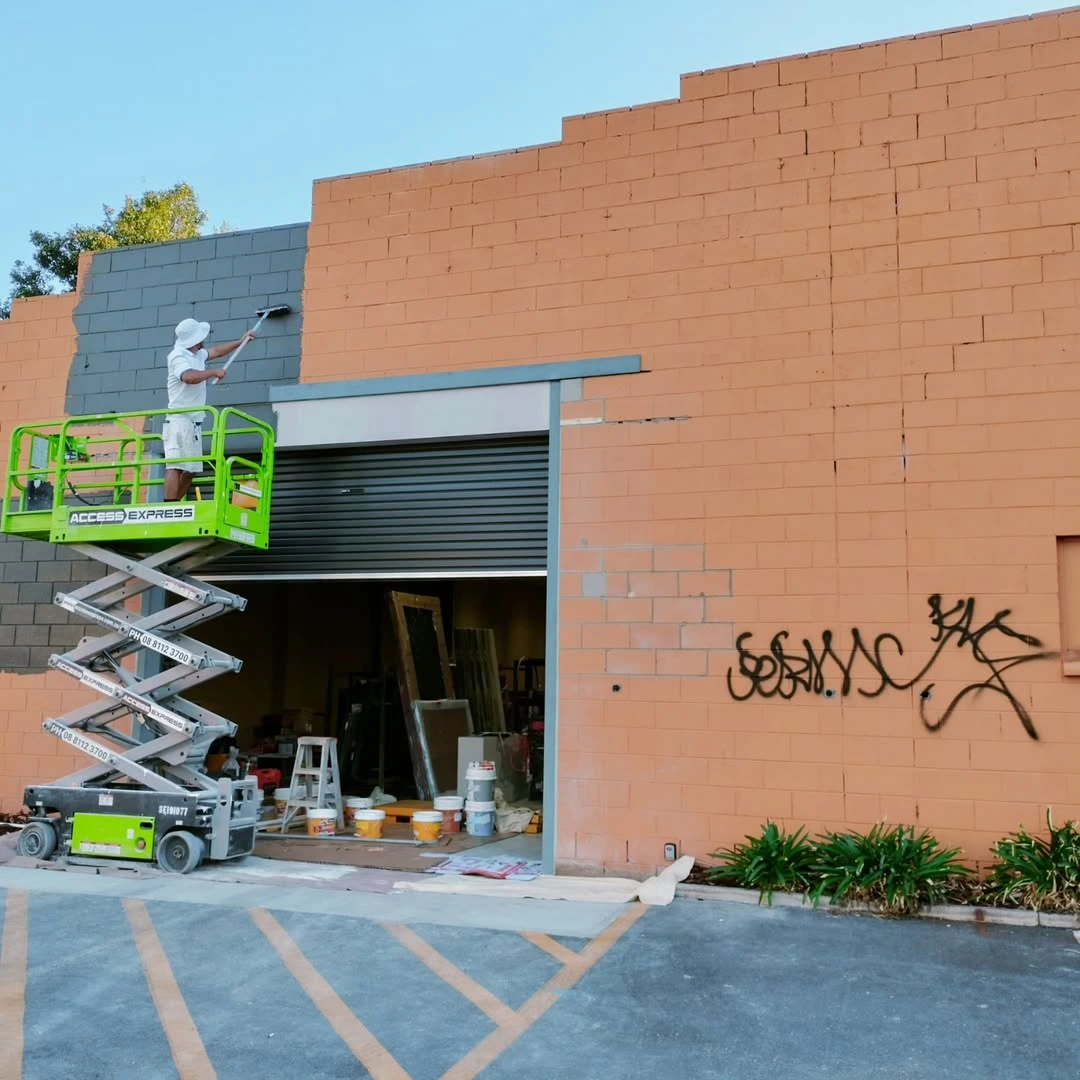 Professional spray and roll painting for commercial exterior walls by SA Prep and Paint.
