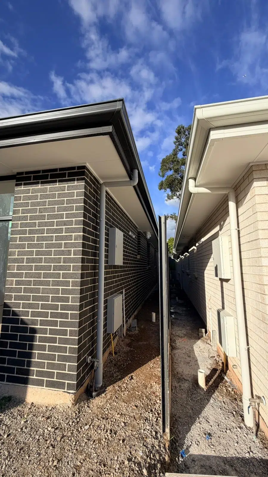 Exterior walls being prepared and painted for a fresh finish.