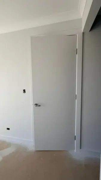 Professional painter applying primer to a wall before painting in Adelaide