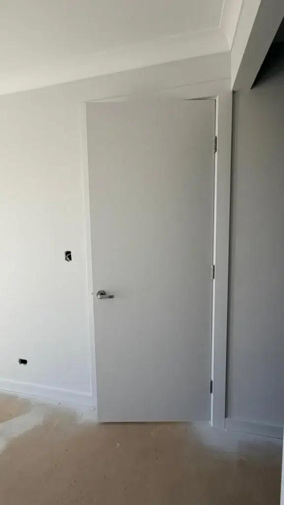 Professional painter applying primer to a wall before painting in Adelaide