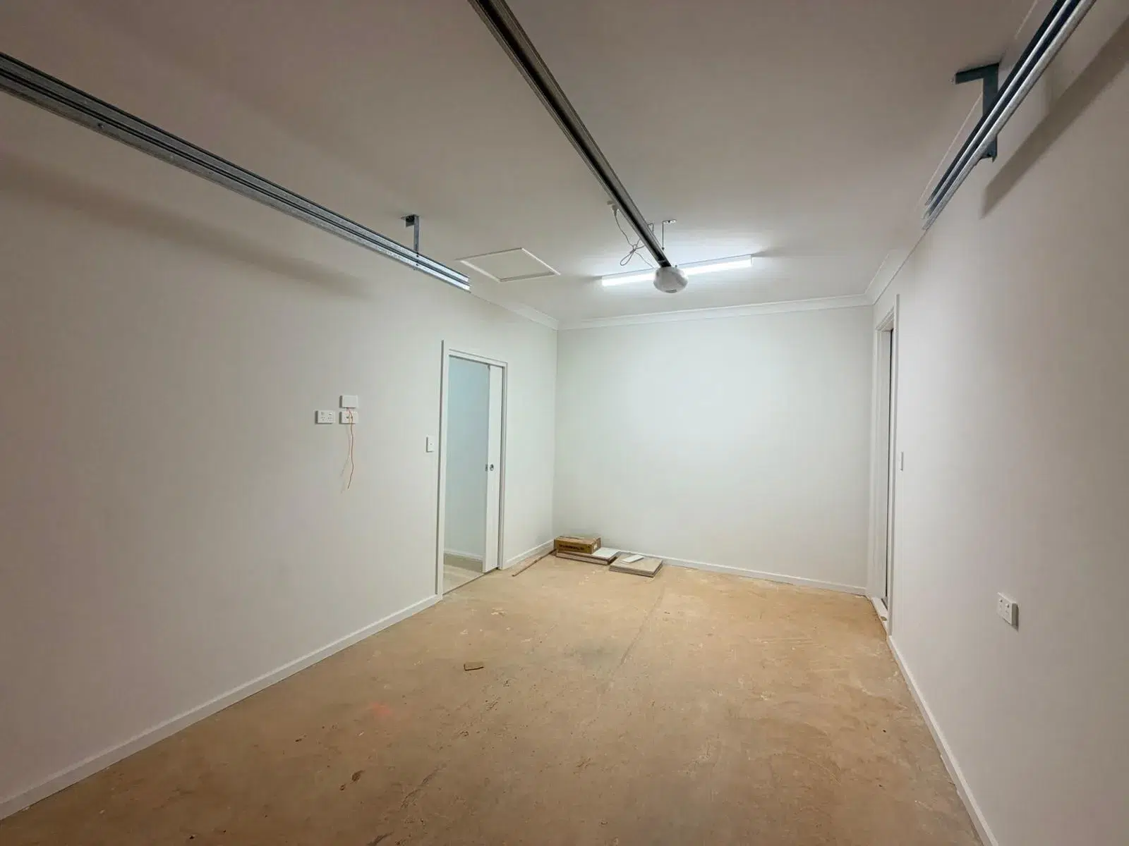 Professional painter applying interior paint to a residential wall in Adelaide